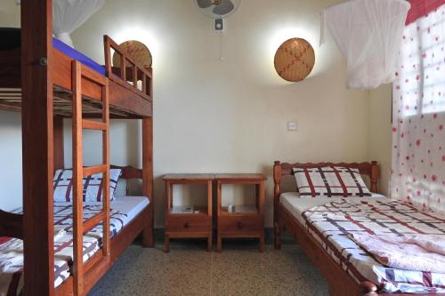 Katil atau katil-katil dalam bilik di Voi Lutheran Guesthouse