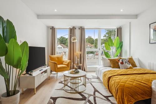 a white living room with a bed and a couch at Apartment in Wimbledon with Cinema, Gym, Game Room! Upto 30 Percent OFF in New Malden