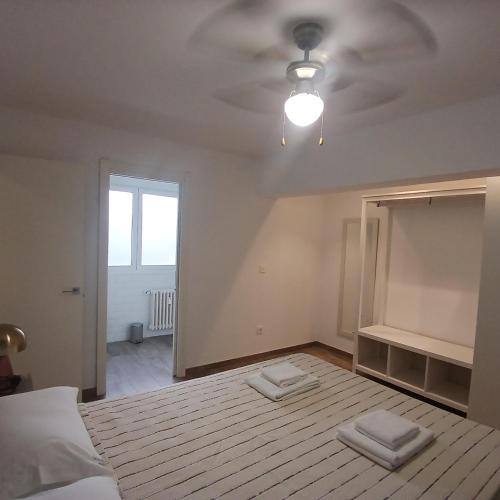 a bedroom with a bed with two towels on it at VALERIA-DREAMS Maestro luna 5,2º in Zaragoza