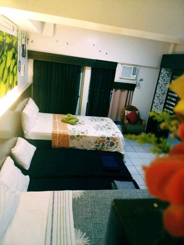 a hotel room with two beds and a chair at Jhohanna's Cozy Corners in Iruhin