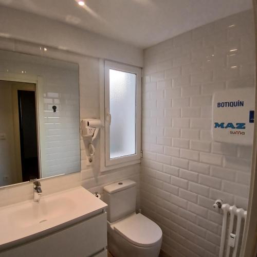 a bathroom with a toilet and a sink and a mirror at VALERIA-DREAMS Maestro luna 5,2º in Zaragoza