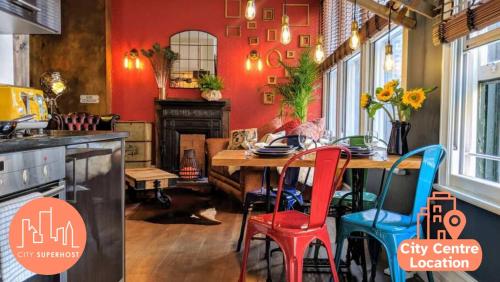 a kitchen with a wooden table and colorful chairs at Boutique City Centre Flat by City SuperHost in Manchester