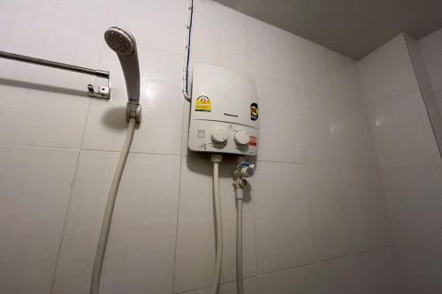 a shower in a bathroom with a shower head at Krabi Orchid Hometel in Krabi town