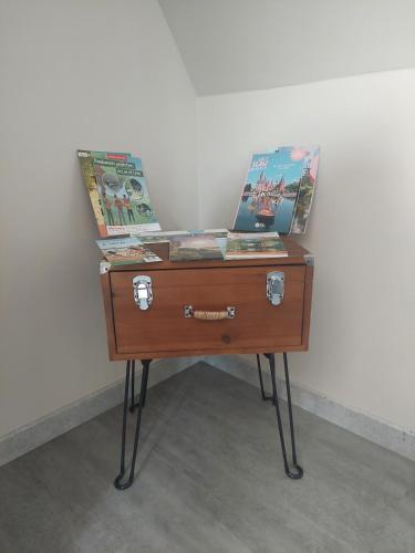 a wooden table with two boxes on top of it at Charmant chalet in Pezou