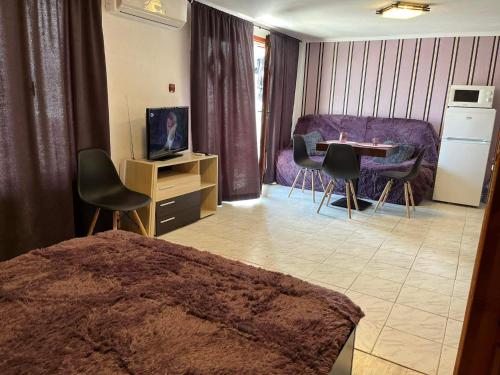 a bedroom with a bed and a table and chairs at Villa Nikoleta in Sveti Vlas