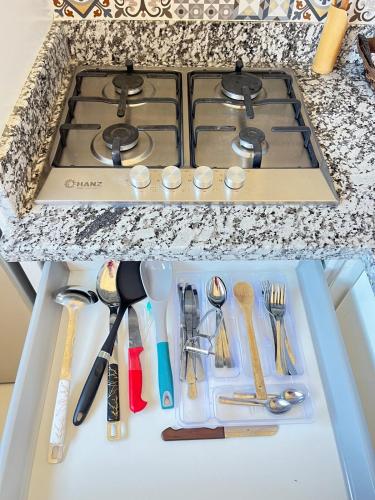 a kitchen counter with a stove and some utensils at La Casa Luminosa 5 in Larache