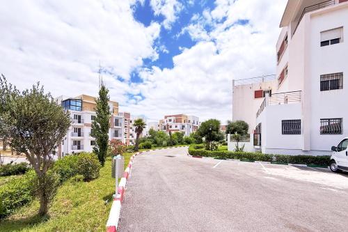 an empty street in a city with buildings at Layla Place in Tangier in Tangier