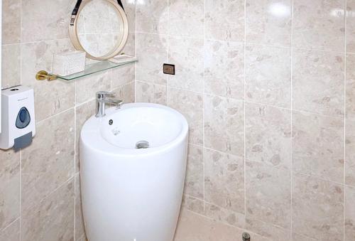 a bathroom with a white sink and a mirror at Layla Place in Tangier in Tangier