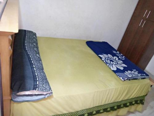 a bed in a room with two blankets on it at Mondy Pyramids Hotel in Cairo