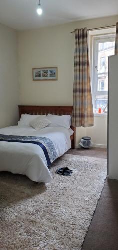 Ένα ή περισσότερα κρεβάτια σε δωμάτιο στο Cosy and Bright 3-bedroom flat