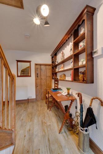 a room with a wooden table and a desk at Wharf in Cromford