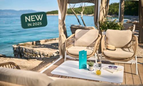 a table with two chairs and a sign that says new in at Aminess Style Glamping Villas & Holiday Homes Atea in Njivice