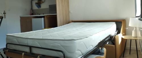 a bed in a room with a mattress on it at Trois Studios-Cosy centre village in Brouckerque