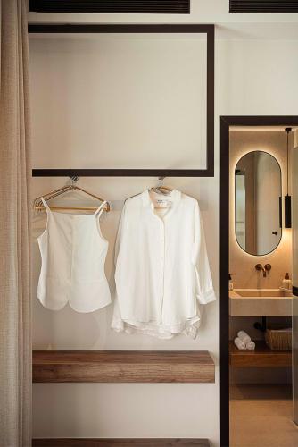 a white shirt and a mirror in a bathroom at Villa Yoma- Luxury Villa with Heated Pool in Epáno Kefalás