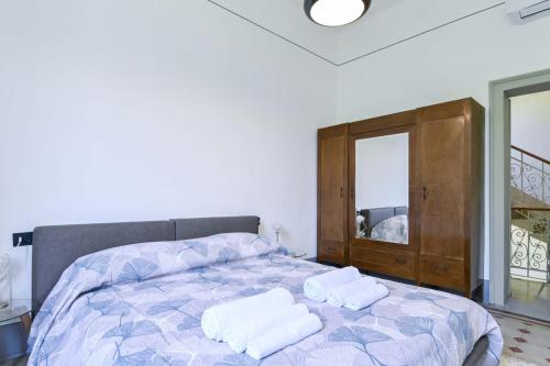 a bedroom with a bed with two towels on it at Villa Giovanna, Beautiful Rooms - by Host4U in Solto Collina