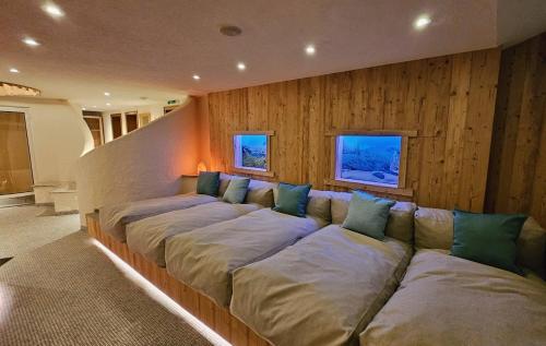 a large couch in a room with wooden walls at Appart Laijola in Gaschurn