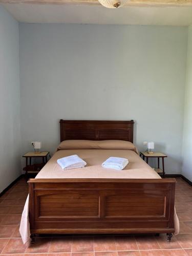 a bedroom with a bed with two towels on it at Dimora Borgo Torre in Rutino