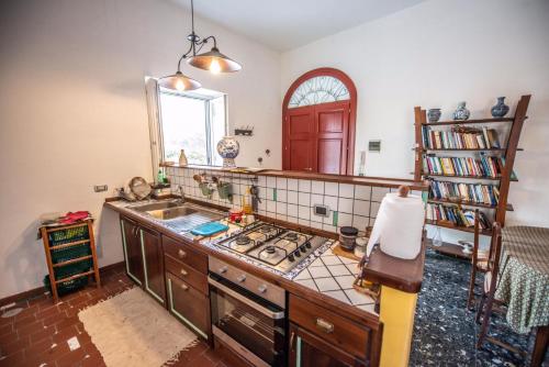 a kitchen with a sink and a stove in it at Il Giardino del Sole in Roccarainola