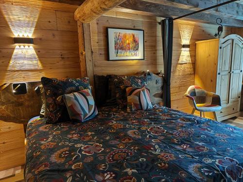 a bedroom with a bed in a room with wooden walls at L' Auberge du château in Génos