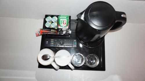 a counter with a coffee pot and measuring cups at Albany, Brighton & Hove in Brighton & Hove
