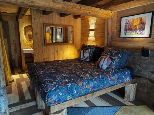 a bedroom with a bed in a log cabin at L' Auberge du château in Génos