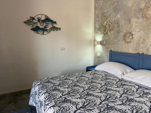 a bedroom with a bed and a wreath on the wall at Sa Funtana in Gonnesa