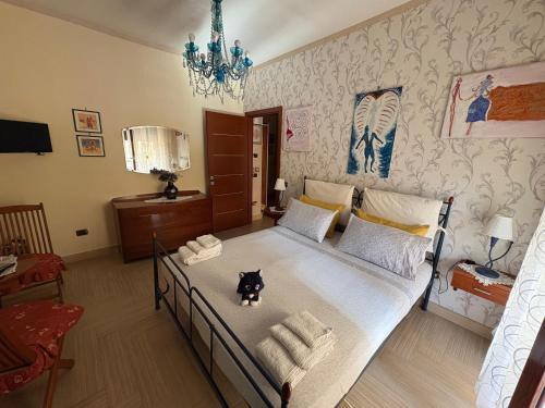 a bedroom with a bed with a dog sitting on it at Casa Vacanze PepeNero in Gragnano