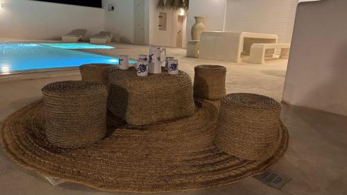 a room with three tables and a pool at VILLA SALAM, Maison D'hôte in Mezraya