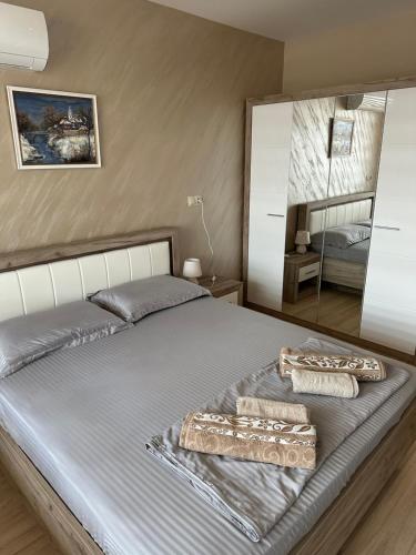 a bedroom with a large bed with a large mirror at Apartment Tuthon in Pomorie