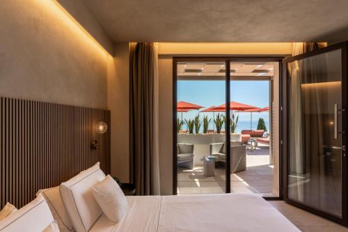 a bedroom with a bed and a view of the ocean at Villa Fiorita Boutique Hotel in Taormina