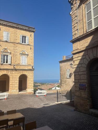 a large brick building with a bench in front of it at Camere al Borgo Affittacamere in Monteprandone