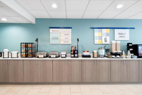a kitchen with a counter top with food on it at Garner Hotel Virginia Beach North by IHG in Virginia Beach