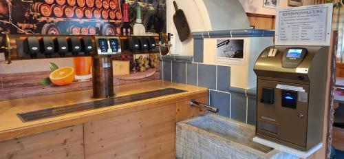 a bar with a drink dispenser in a restaurant at ROSSLWIRT-Rast in Strass im Attergau