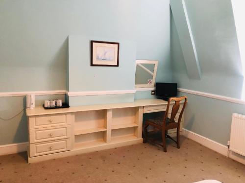 a desk with a mirror and a chair in a room at Albany, Brighton & Hove in Brighton & Hove