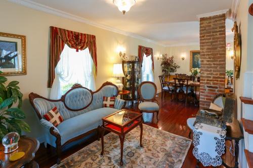 a living room with a couch and a table at Ma Margarets House Bed and Breakfast in Heathsville