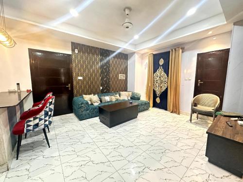 a living room with a couch and a table at One Bed Executive Apartment in Islamabad