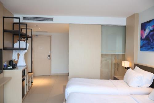 a hotel room with two beds and a bathroom at Modern Beach Apartment - Arena Resort Cam Ranh in Cam Ranh International Airport