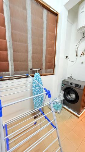 a towel rack in a laundry room with a washing machine at Cozy apartment 2 omnisports in Yaoundé