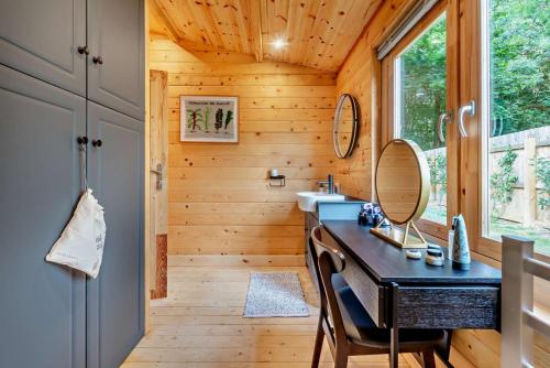 a bathroom with a sink and a mirror at Woodlands Lavender Lake House in Long Bennington