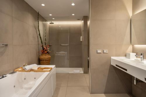 a bathroom with a shower and a sink and a toilet at Villa Fiorita Boutique Hotel in Taormina