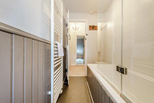a bathroom with a bath tub and a sink at Rose Cottage in Youlgreave