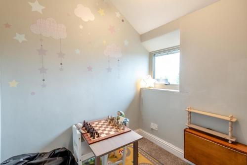 a childs room with a chessboard on the wall at Hawkfield in Baslow