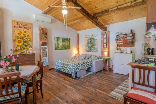 a bedroom with a bed and a table and a kitchen at Casa di Cristina in Casamaggiore