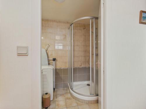 a shower in a bathroom with a glass door at Maison en pierre avec jardin pour 4 personnes in Erquy