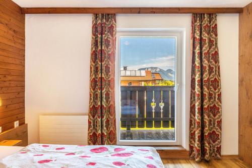a bedroom with a window with a view at Pension Heidelberg in Hopfgarten im Brixental