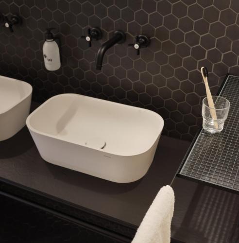 a bathroom with a white tub and a sink at BERCAIL in Wambrechies
