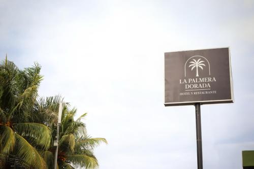 a sign for la jumeirah dolbury with palm trees at La Palmera Dorada in Managua