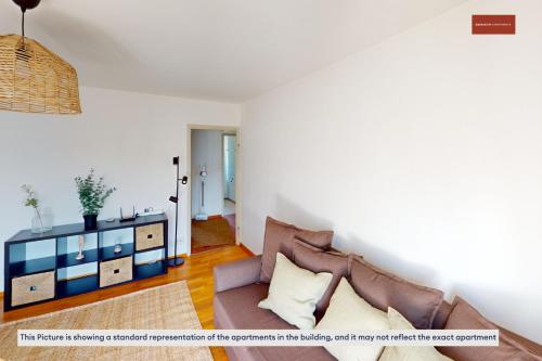 a living room with a couch and a table at Relax with Room to Spare 3-Bedroom Zurich Stay in Zürich