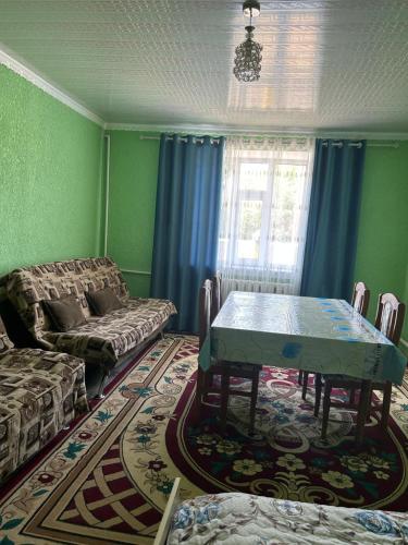 a living room with a table and a couch at Green Forest guest house in Ivano-Alekseyevka