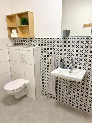 a bathroom with a toilet and a sink at el Gotel in Čadca